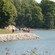 People biking, walking and walking with Nordic walker poles, on a path near the water in Helsinki